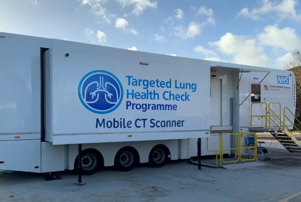 picture of one of the mobile scanning units for lung health checks. Large lorry type vehicle with steps at the side