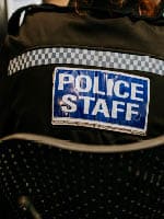 Image of police uniform, saying 'Police Staff' on the back.
