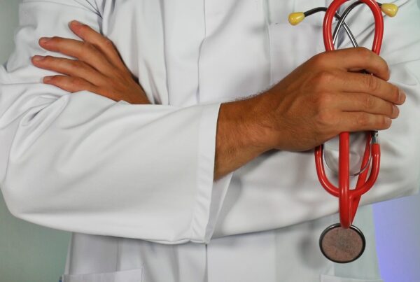 picture of a doctor in a white coat holding a stethoscope