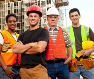 Picture of three men and a women working on a building site with hard hats and high vis tops