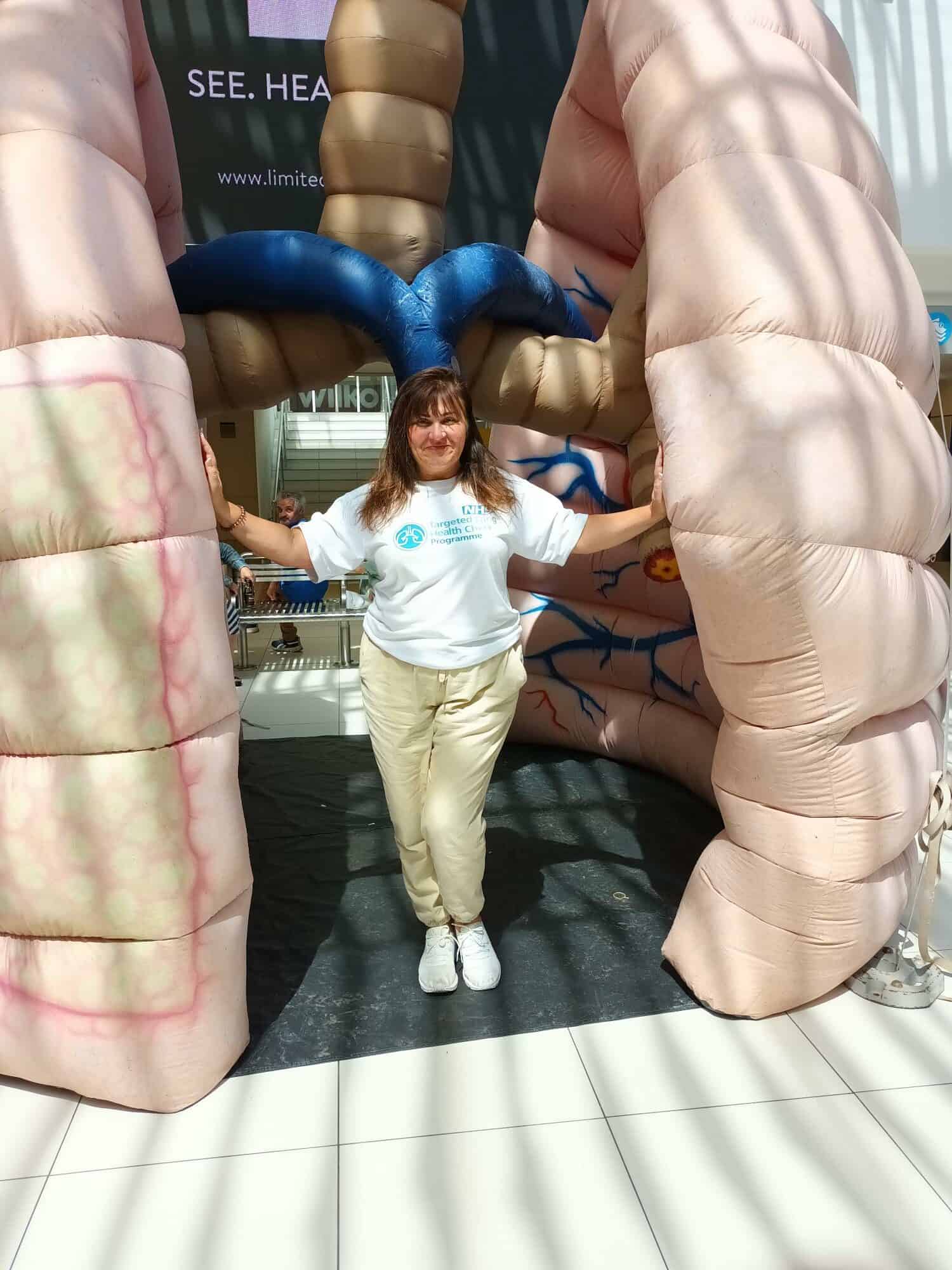 Woman stood in between giant inflatable lungs